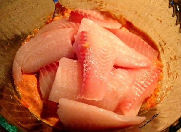 fish marinated in a bowl with tandoori spices and yogurt for Tandoori Fish Tikka