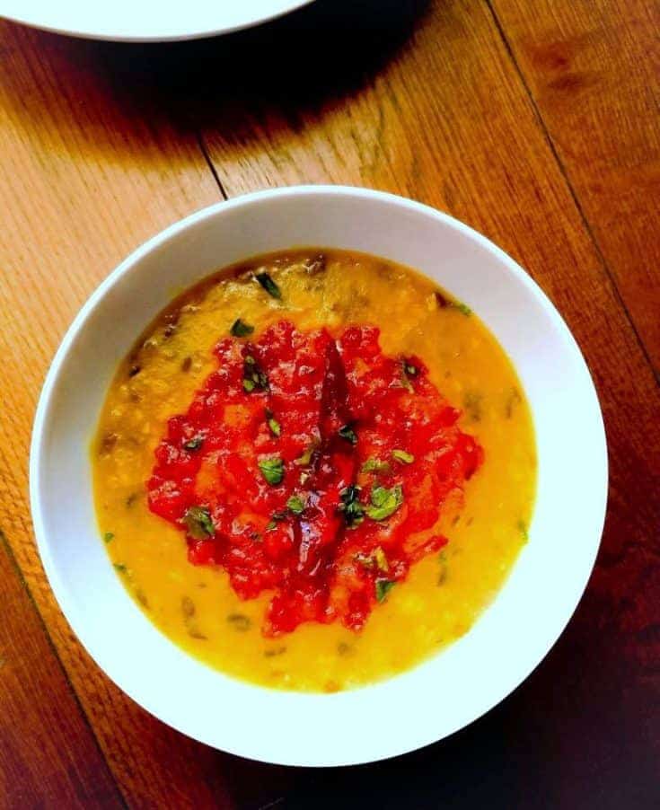 dal tadka or dal fry in a large white bowl with red tadka on top