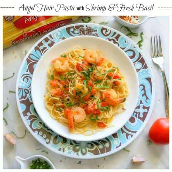 angel hair pasta with shrimp recipe on a white and blue plate