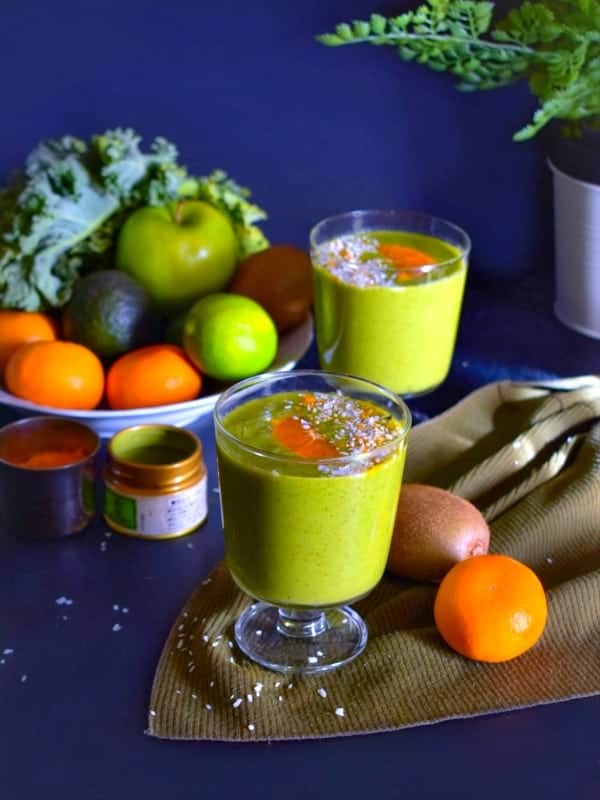 Loaded immunity boosting green smoothie recipe with fruits around it