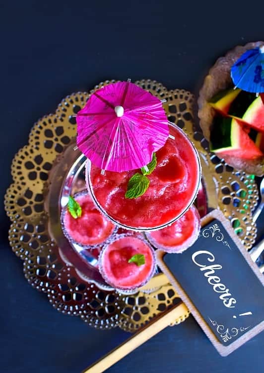 Watermelon Vodka Slushie in 3 glasses with cocktail umbrellas