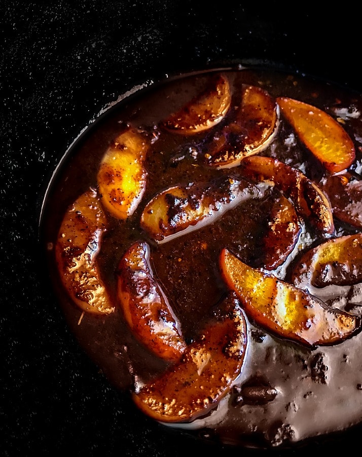 peach ginger-bbq sauce in a skillet with chopped peaches