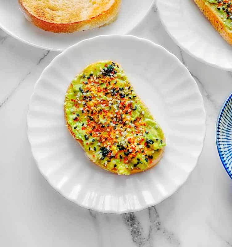 vegan avocado toast topped with turmeric and sesame seeds