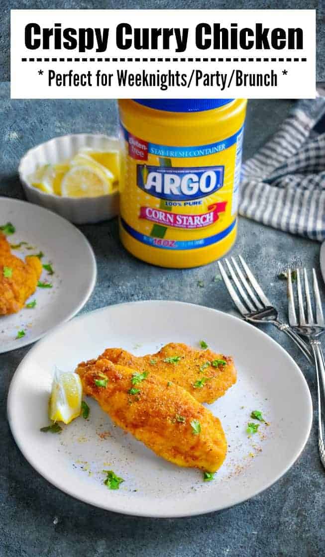 Crispy Curry Fried Chicken on a white plate with lemon wedge