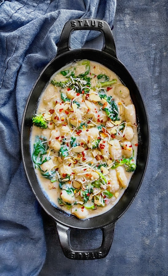 Baked Creamy Spinach Gnocchi using cashew milk, cheese and almond flakes