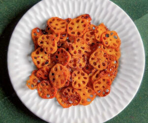 air-fryer sweet chili lotus stem chips on a white plate